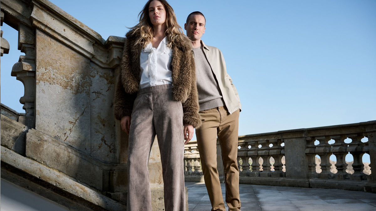 Couple wearing MAC Jeans outfits, styled together at a historic outdoor location.