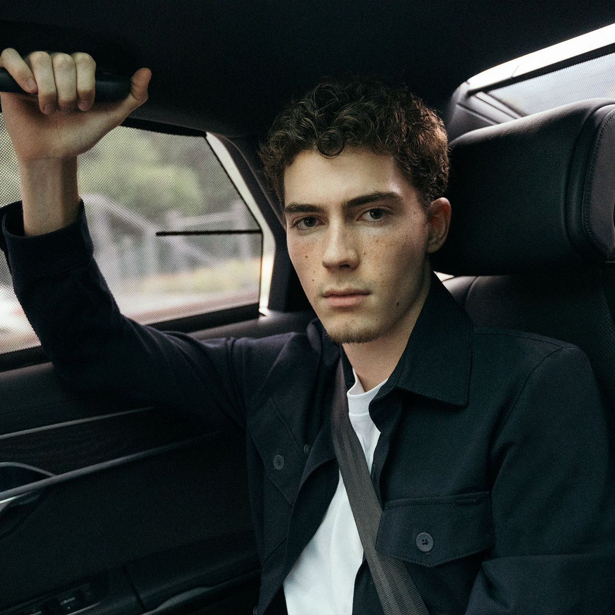 Valentin Kluss wearing a dark MAC Jeans look while sitting inside a car.