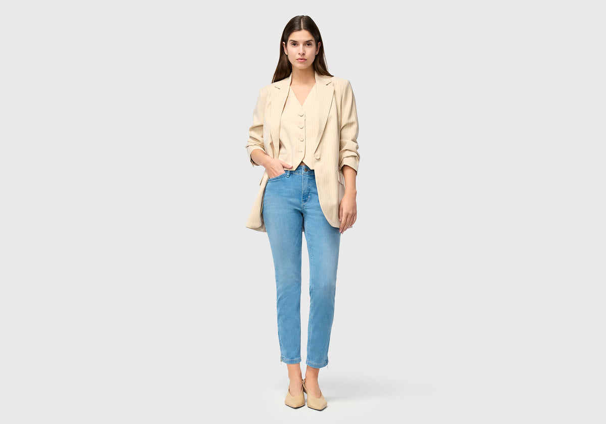 Woman wearing Dream Chic in light blue with streamlined leg and cropped length.