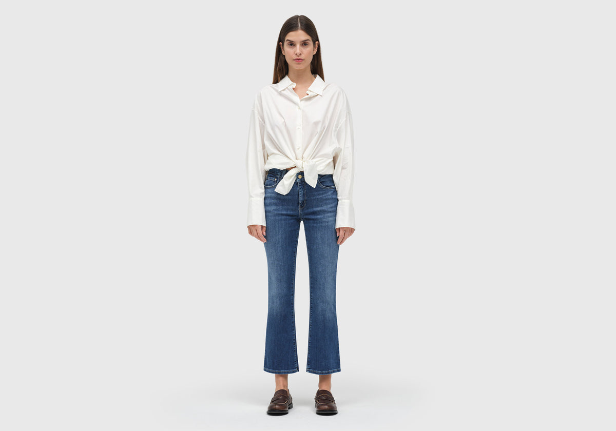 Woman wearing Dream Kick flare jeans with wider hem and modern, fashion-forward fit.