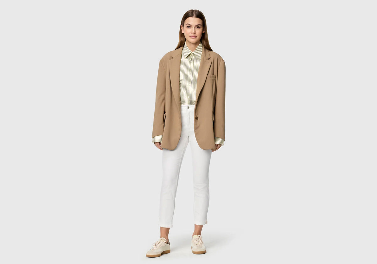 Woman wearing white Dream Summer slim fit pants with clean silhouette and ankle-length cut.