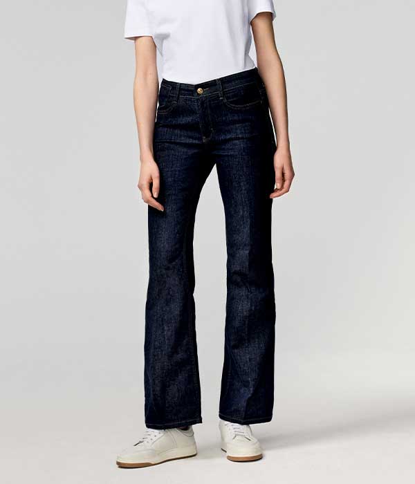 Women’s flared jeans in dark blue denim with slim fit through hip and thigh and subtle flare at the hem.