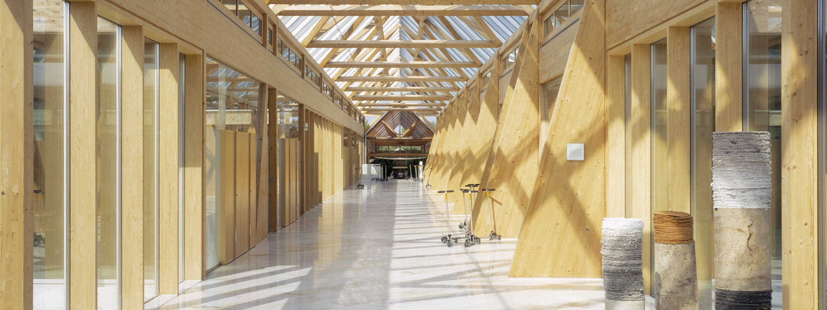 Bright wooden corridor with glass roof inside the MAC headquarters.